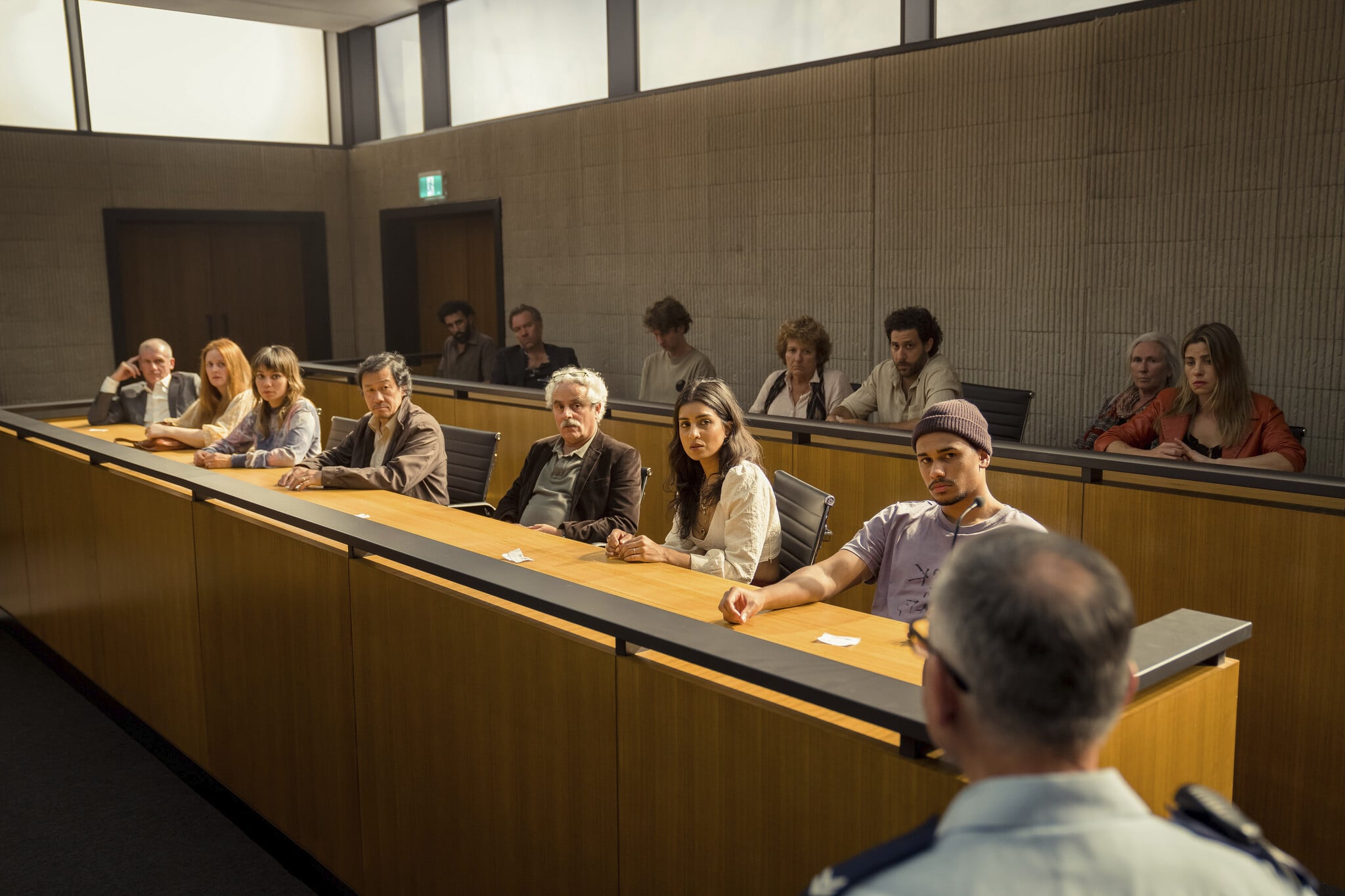 The Jury in THE TWELVE: (Back row L-R) Hazem Shammas as Farrad, Brendan Cowell as Garry, Toby Blome as Number 8, Gennie Nevinson as Margaret, Damien Strouthos as Alexi,  Susan Kennedy as Mel, Brooke Satchwell as Georgina. (Front row L-R) Nic Cassim as Simon, Bishanyia Vincent as Lily, Catherine Van-Davies as Vanessa, Warren Lee as Trevor, Daniel Mitchell as Peter, Pallavi Sharda as Corrie, Ngali Shaw as Jarrod (image - Brook Rushton)